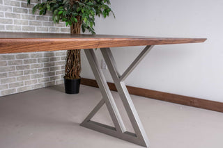 minimalist walnut table on nickel colored steel legs