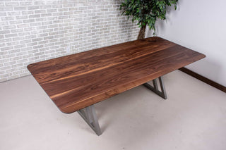 minimalist walnut table on nickel colored steel legs