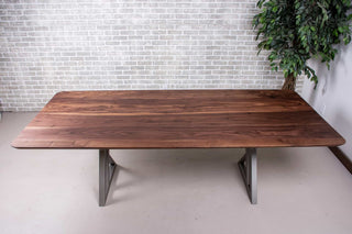 minimalist walnut table on nickel colored steel legs